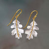 Boho earrings in gold with white leaves