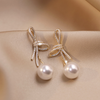 Pearl Earrings with Shiny Bow in Gold